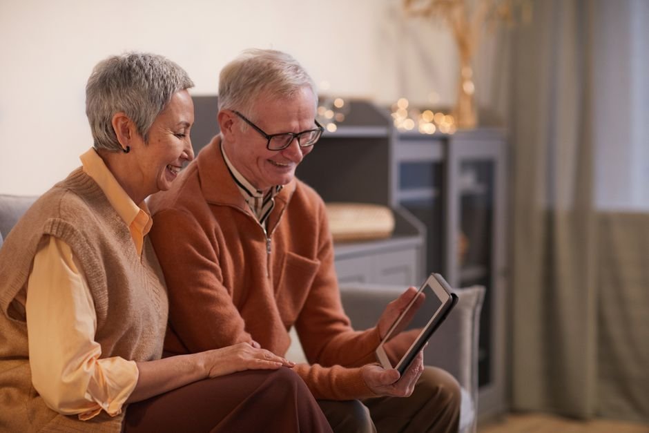 Grandparents on a video call with family on a tablet