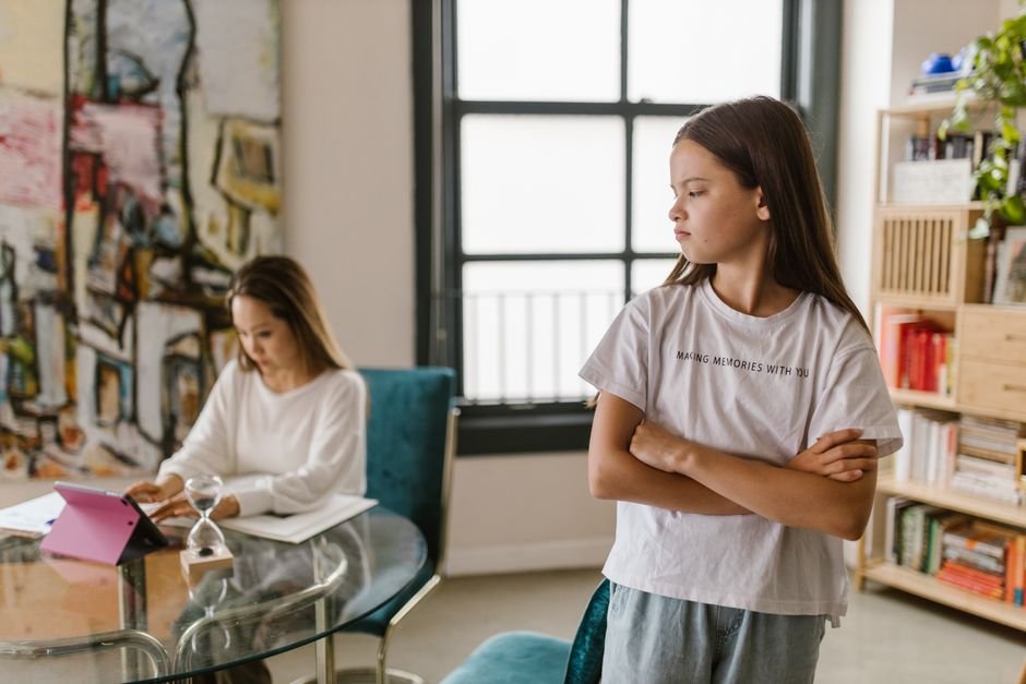 A child turning away from a parent at the table